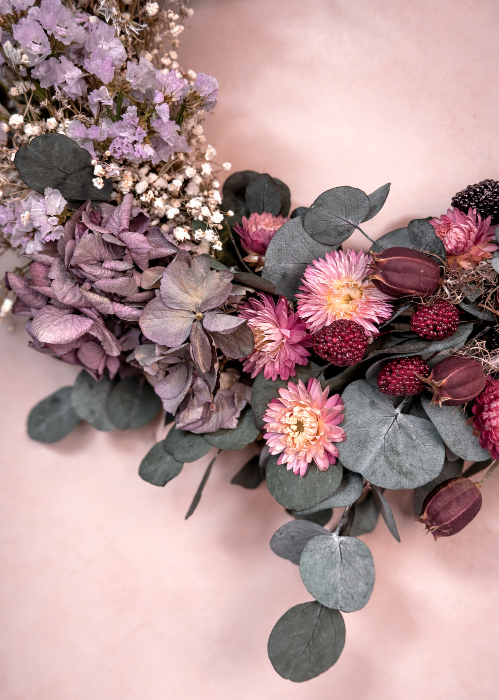 Bouquet of flowers with pink and purple hues on a soft pink background