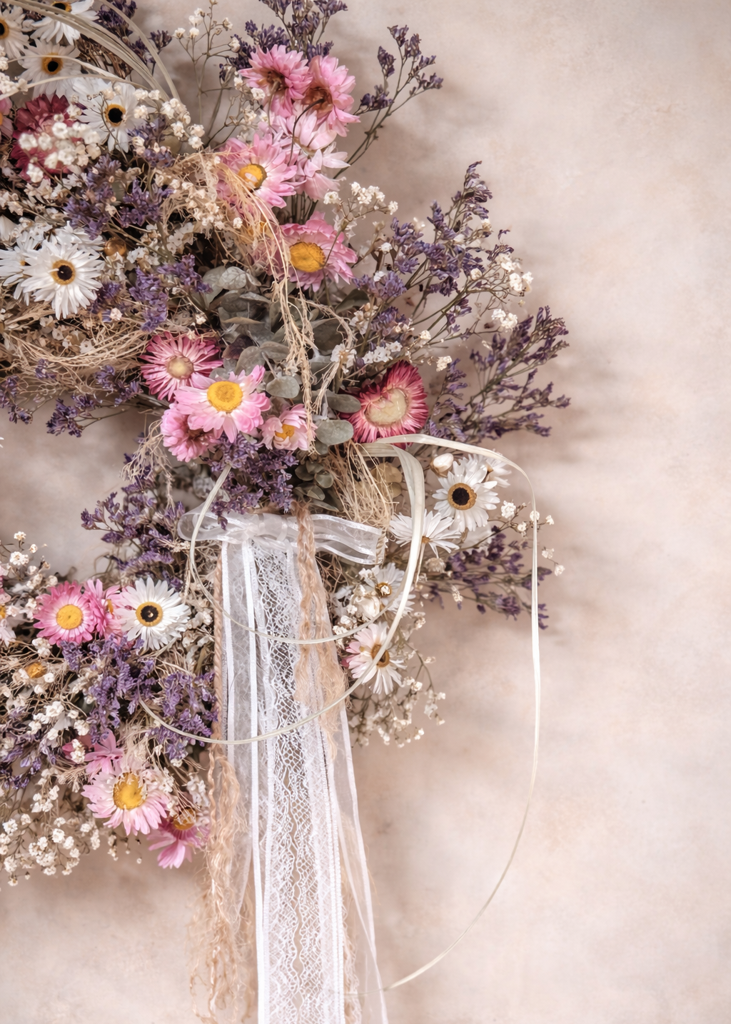 Handmade dried floral wreath with blush pink, lavender and white flowers, including eucalyptus foliage, daisies and gyp for a soft spring look.