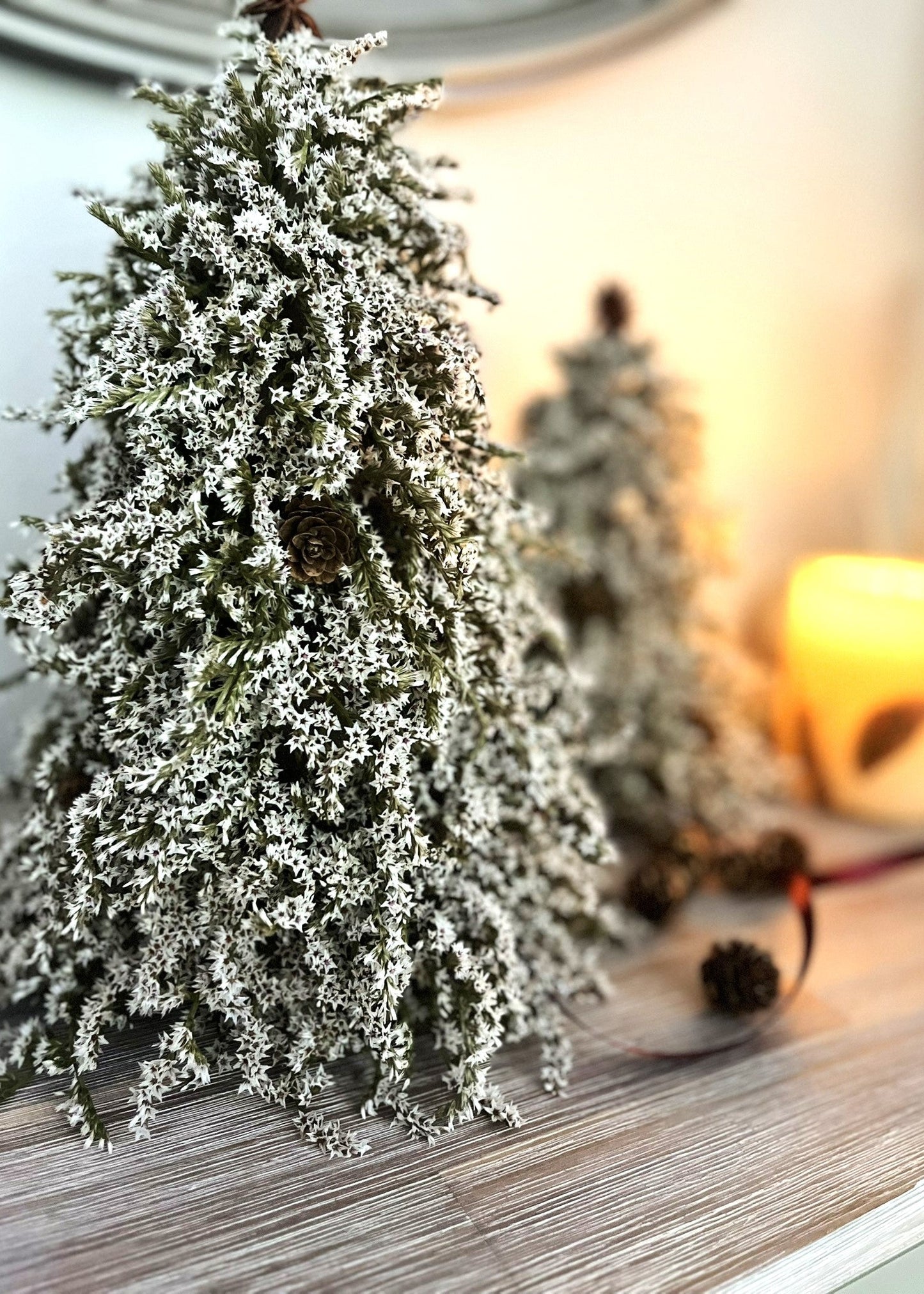 white statice christmas tree with cones